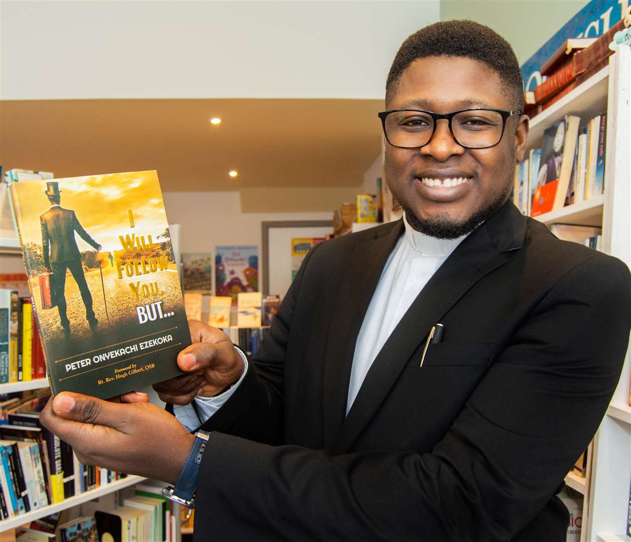 Fr Peter Ezekoka with his book I Will Follow You, But. Picture: Daniel Forsyth