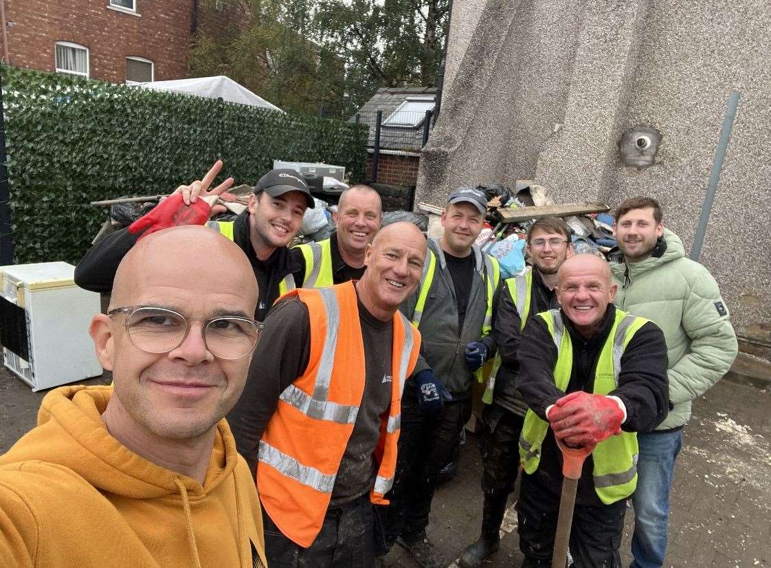 Pastor Paul Hollingworth (front) standing with workers from the council in Chesterfield during the clean-up process following heavy flooding (Paul Hollingworth/PA)