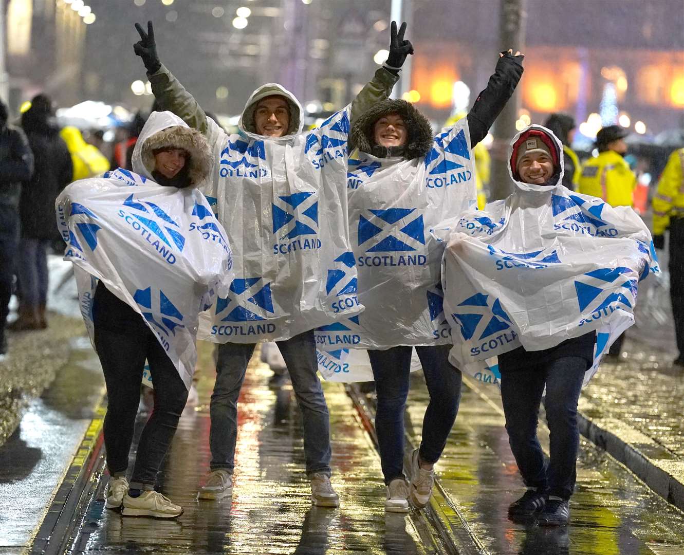 Hogmanay revellers dressed for the weather in Edinburgh (Andrew Milligan/PA)