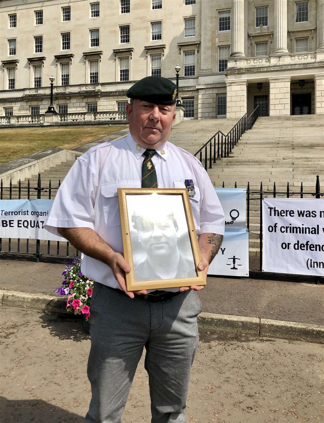 UDR veteran David Newell hold a picture of his murdered cousin lance corporal Kenneth Newell (David Young/PA)