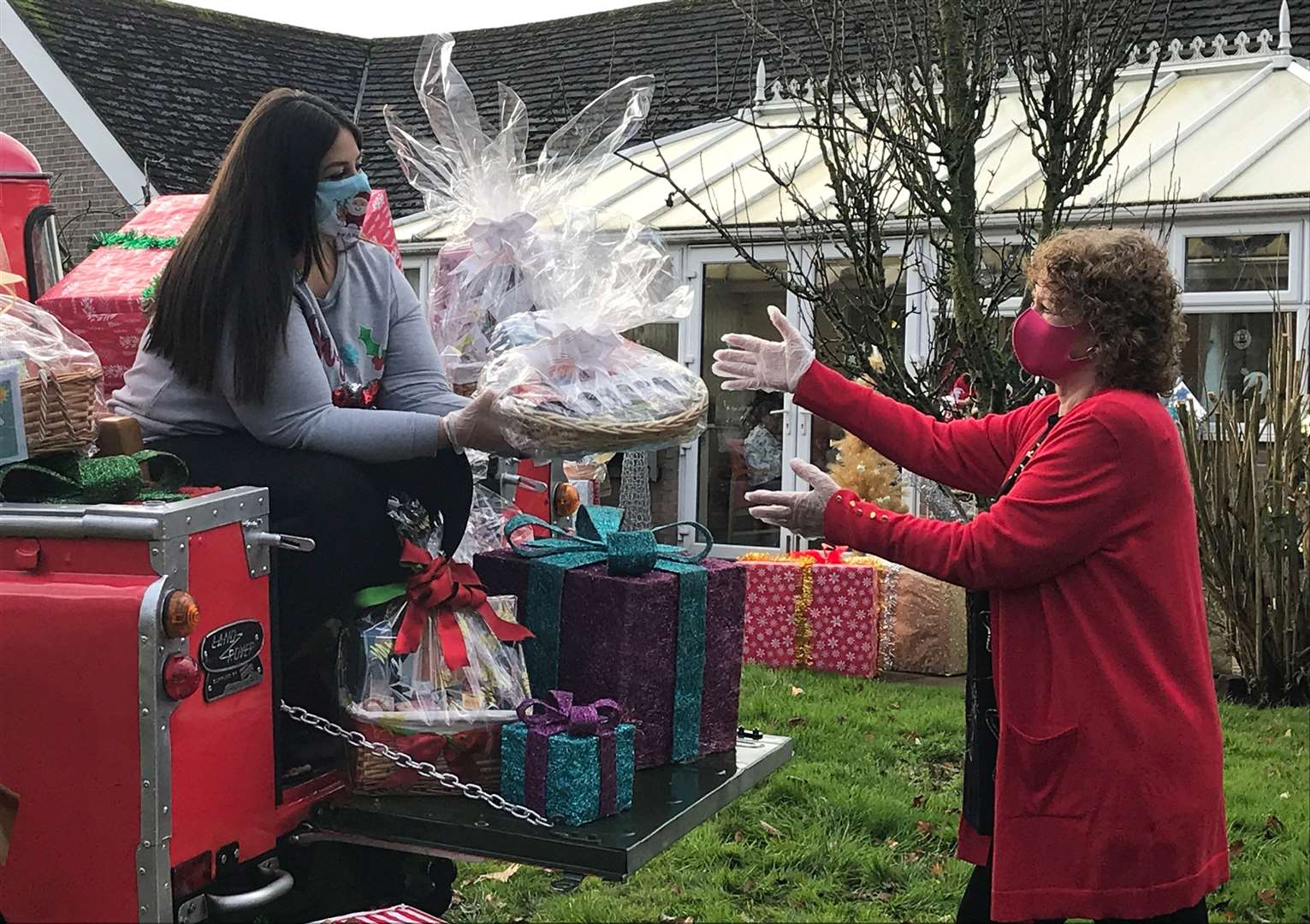 Lottery winner Natalie Cunliffe delivers a Christmas hamper to carer Norma Kirby at Charnley Fold Day Centre in Bamber Bridge near Preston (Richard McCarthy/PA)