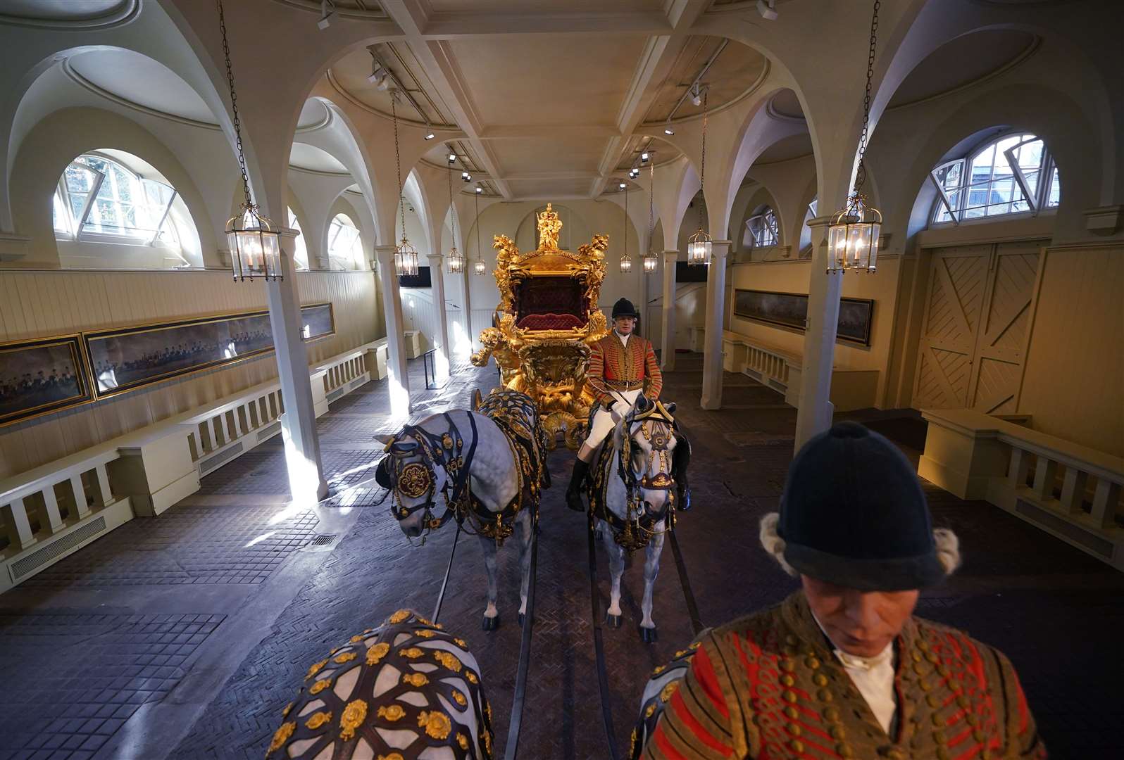 The Gold State Coach with models of horses in the Royal Mews (Yui Mok/PA)