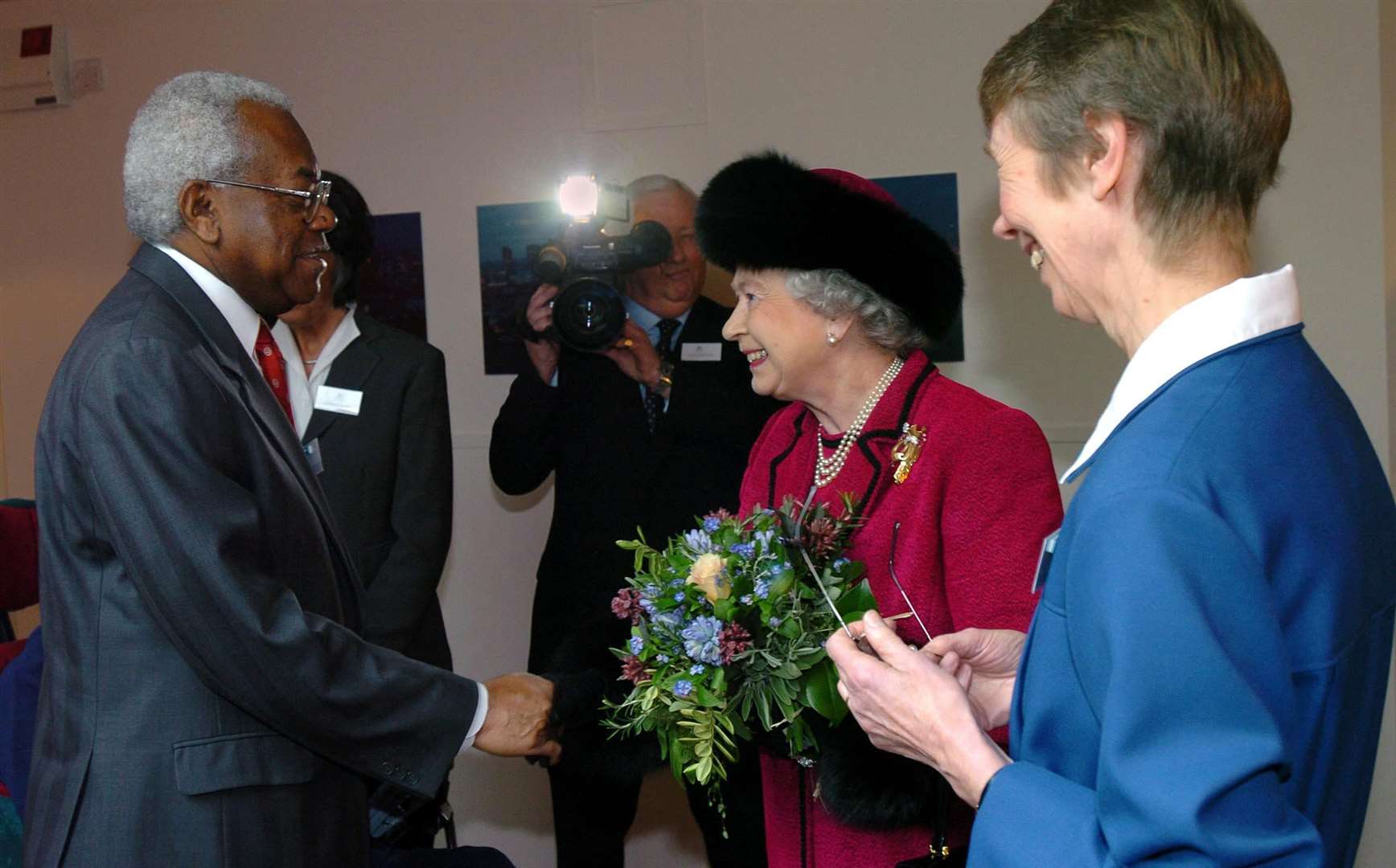 The Queen being filmed meeting broadcaster Sir Trevor McDonald (Tim Ockenden/PA)