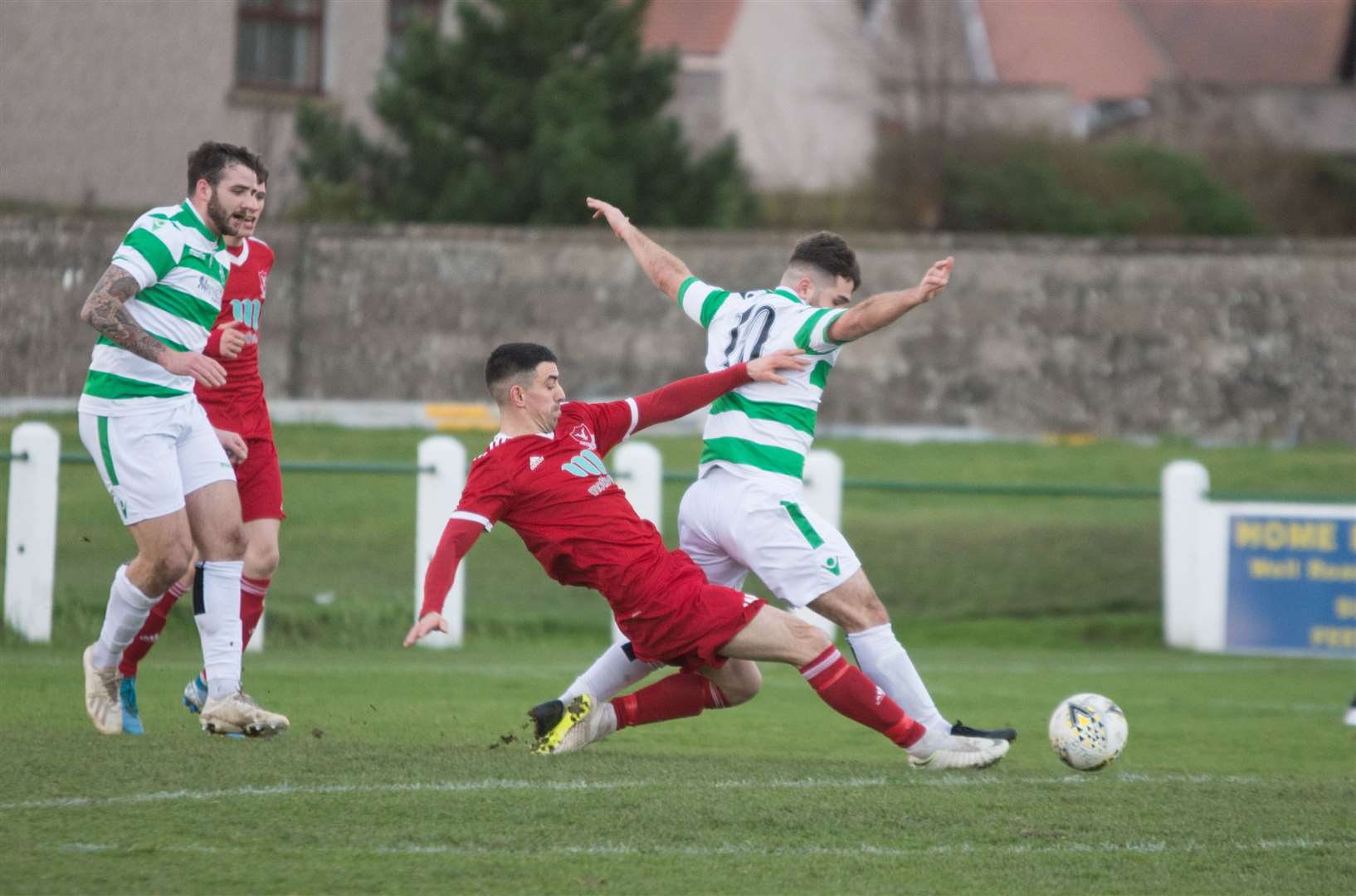 Matthew Wallace slides in on Andrew MacAskill...Buckie Thistle v Deveronvale at Victoria Park, Buckie. ..Picture: Becky Saunderson..
