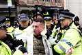 Tommy Robinson escorted from march against antisemitism as man arrested