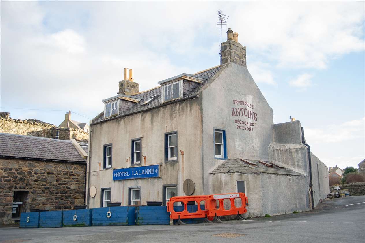 The Shore Inn was renamed 'Hotel Lalanne' and painted in a murky white colour. It also has a French logo added to the side of the building which says 'Enterprise Antoine Negoce de Poissons'. Picture: Daniel Forsyth
