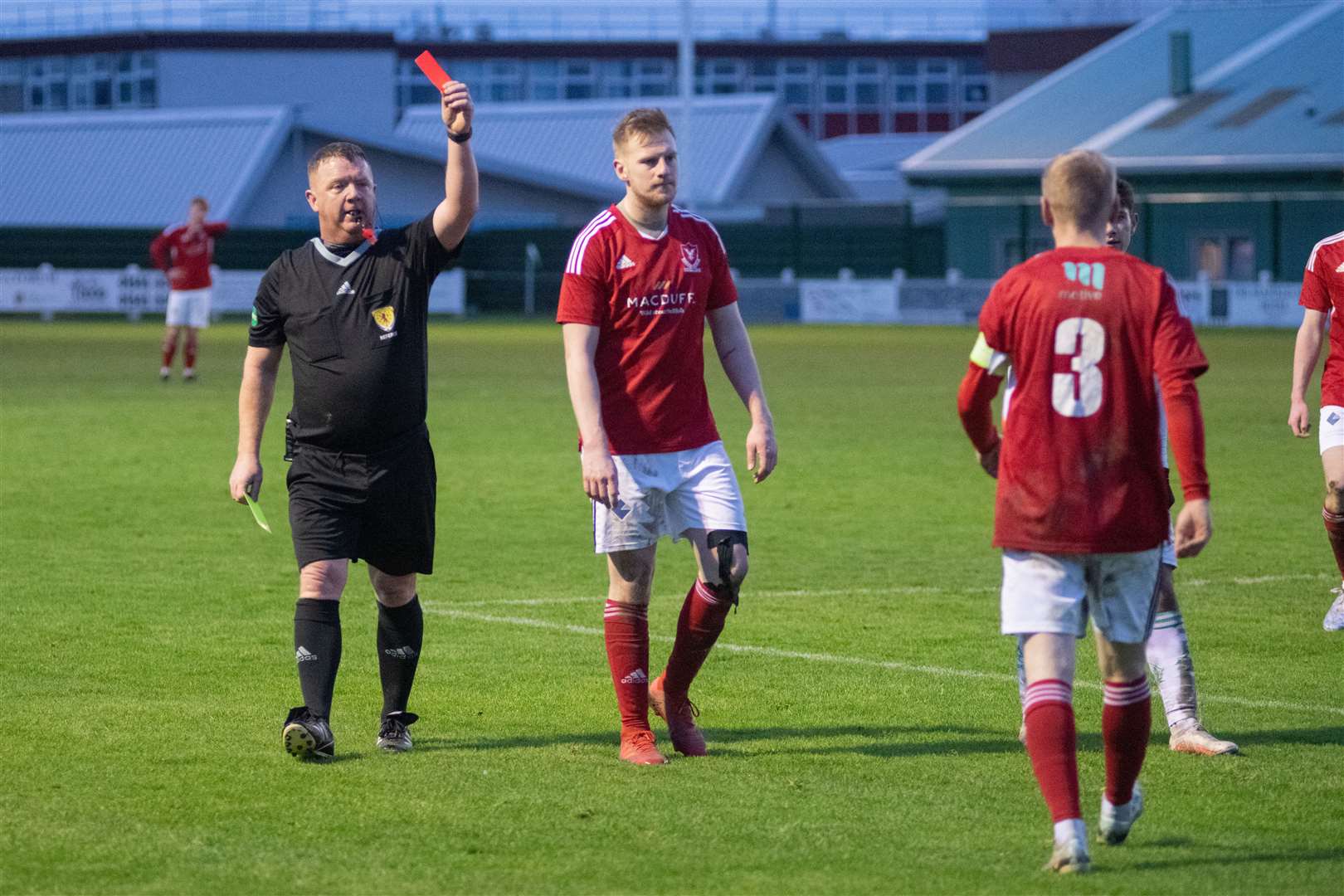 A late red card for Deveronvale captain #3 Harry Noble from referee Alan Proctor...Buckie Thistle FC (3) vs Deveronvale FC (2) - Highland Football League 22/23 - Victoria Park, Buckie 03/01/2023...Picture: Daniel Forsyth..