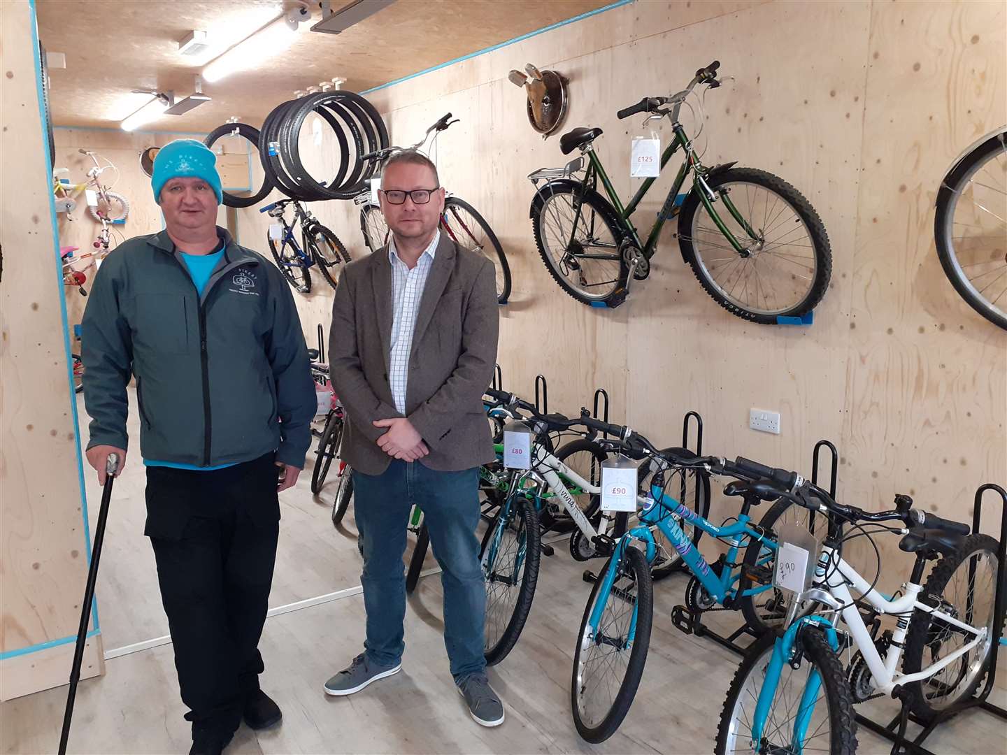 Stuart Pow, Volunteer Mechanic, and Richard Thomson MP with some of the bikes on offer at The Bikery, Gordon Street, Huntly.