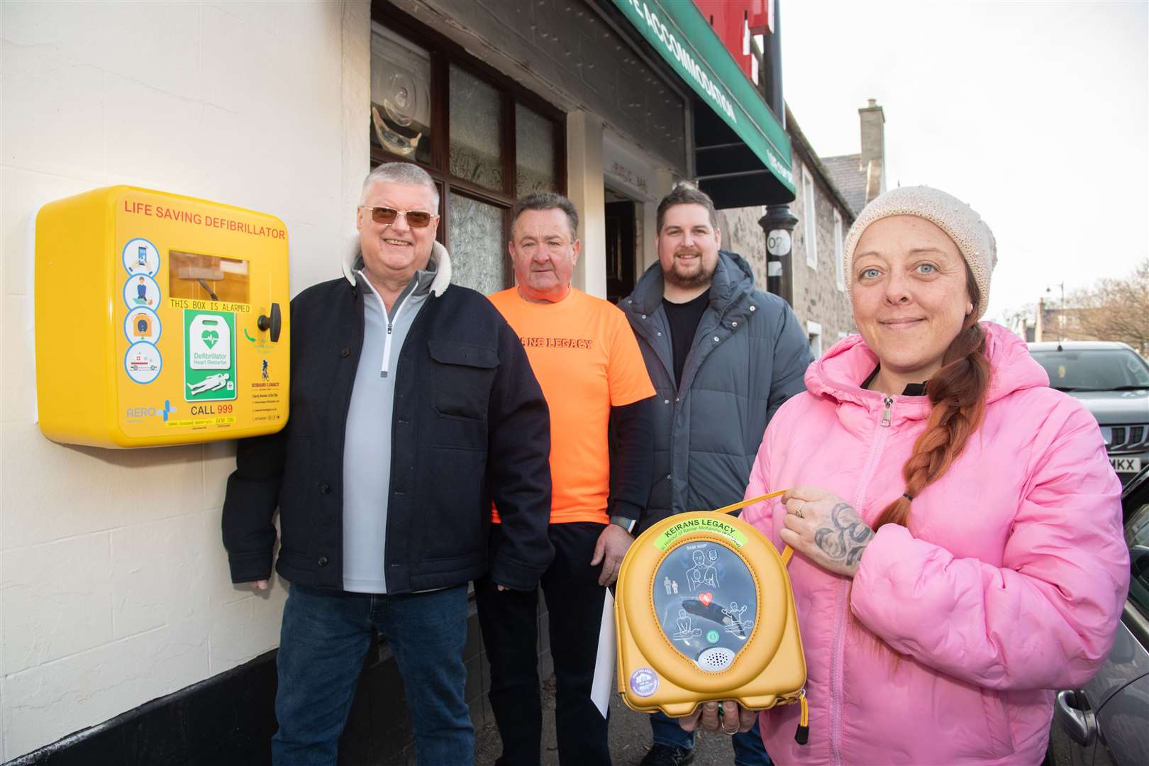 From left; Johnny Russell, Gordon McAndie, Callum Russell and Mel Cliff stand outside Fochabers' Red Lion Taven after raising money to install a defibrillator outside the premise. Picture: Daniel Forsyth