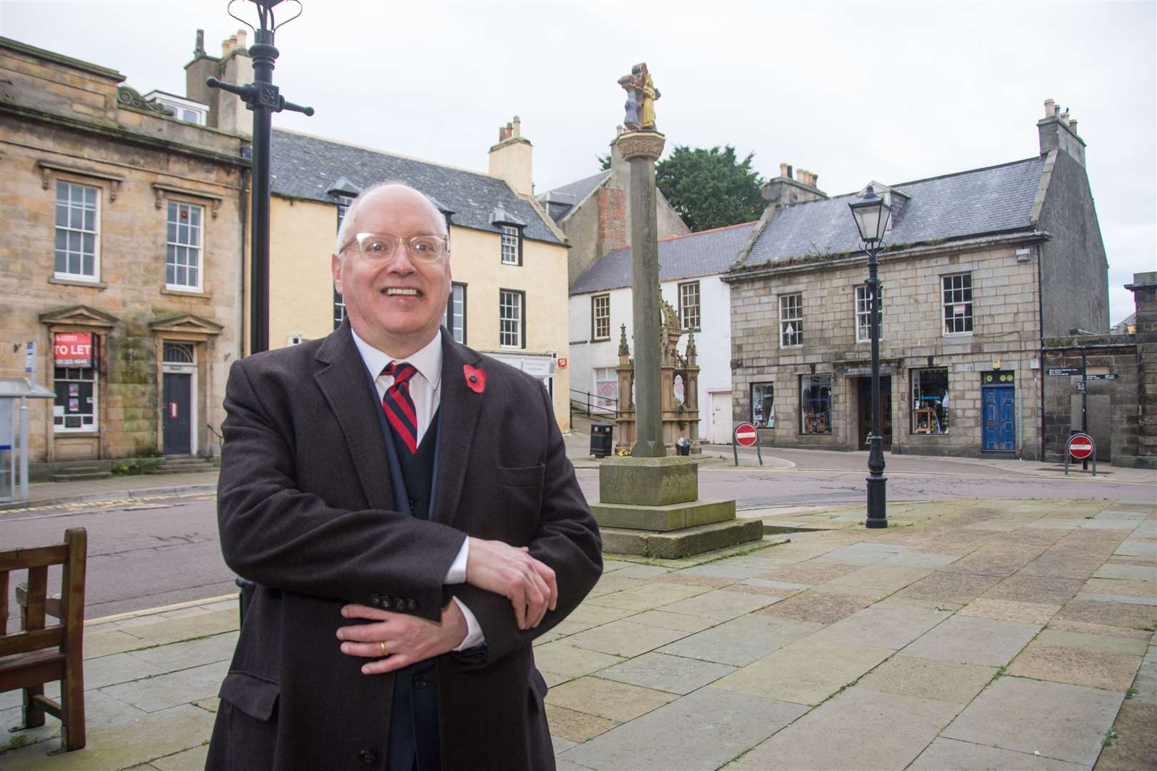 Banff and District SNP Councillor Glen Reynolds outside the Broken Fiddle café and The Merkat Cross in Banff where James Macpherson was hanged in 1700. Picture: Becky Saunderson.
