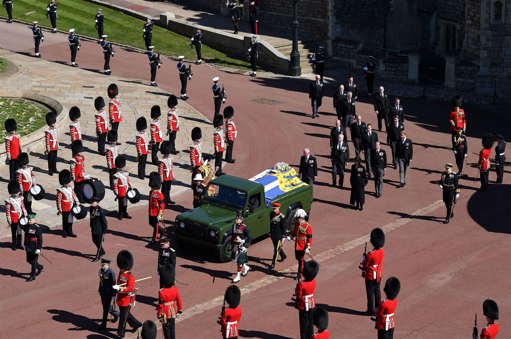 The Duke of Edinburgh’s coffin, covered with his Personal Standard, is carried on the purpose built Land Rover Defender (Justin Tallis/PA)