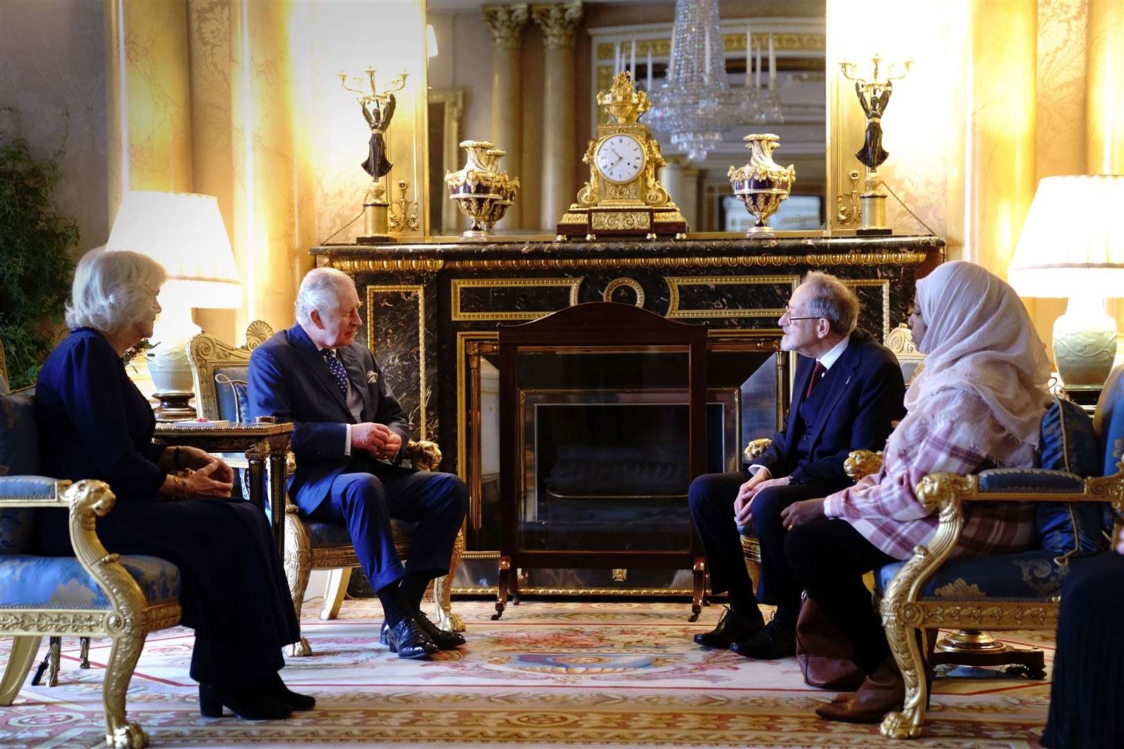 The King and the Queen Consort meet with Holocaust survivor Dr Martin Stern and a survivor of the Darfur genocide, Amouna Adam (Victoria Jones/PA)
