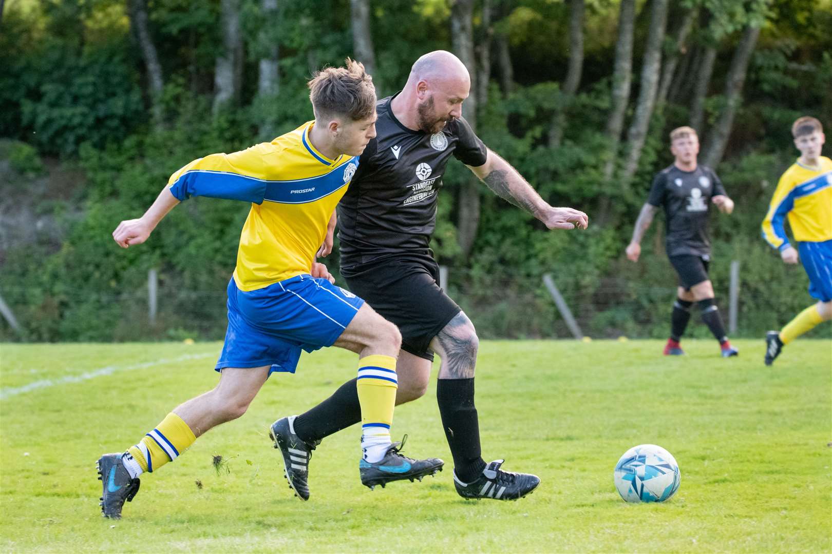 Craigellachie midfielder Steven Chalmers holds off a challenging Ethan Cole of visitors Portsoy...Picture: Daniel Forsyth..