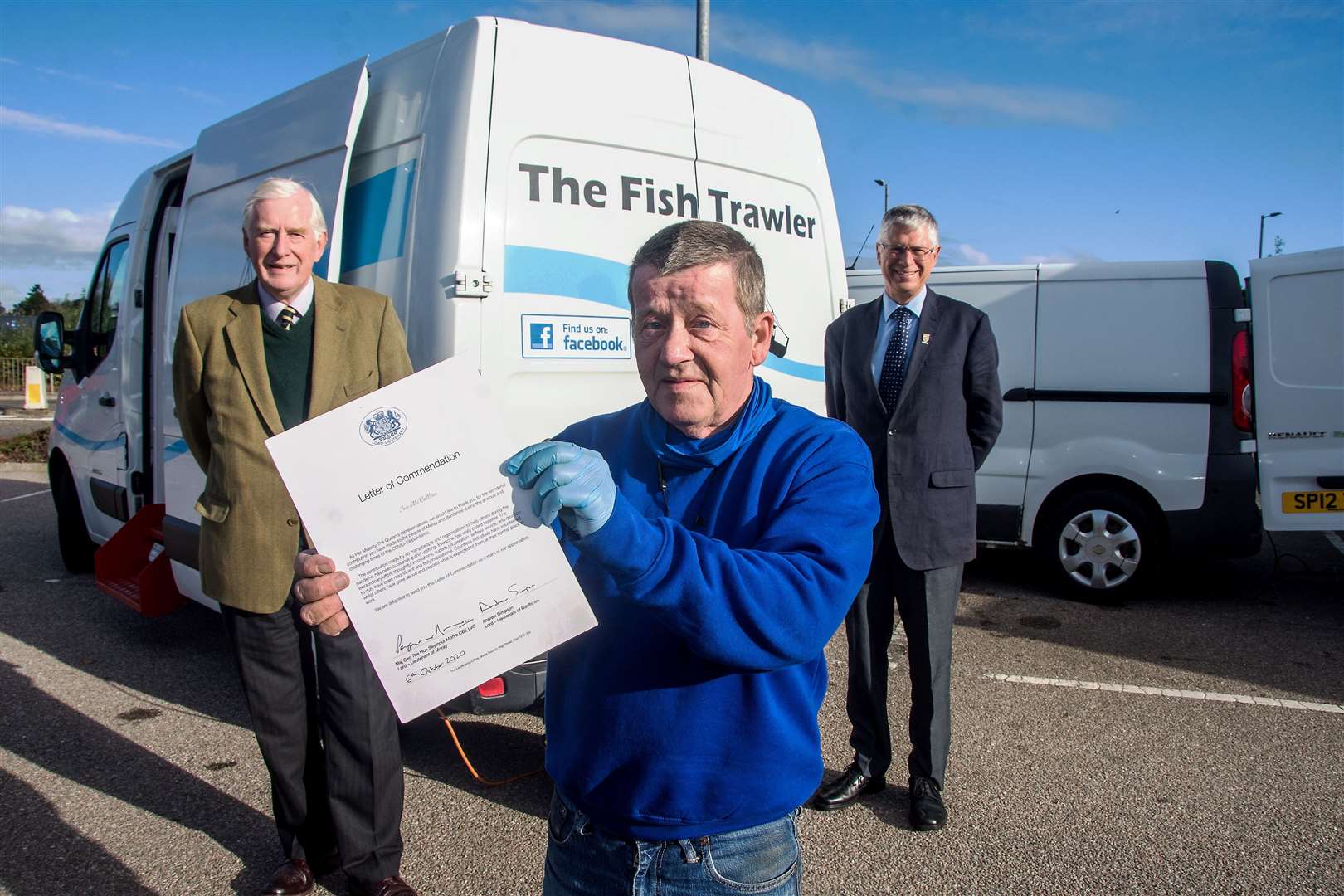 Ian McCallion proudly shows off his commendation, joined by Seymour Monro (back left) and Andrew Simpson, the Lord-Lieutenants of Moray and Banffshire respectively. Picture: Becky Saunderson