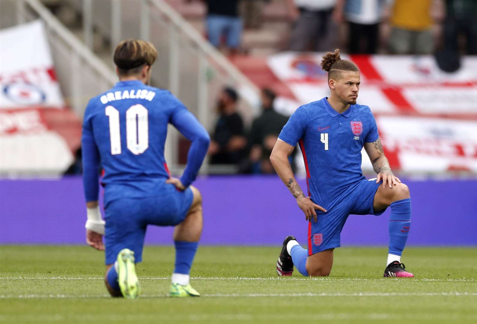 England’s Jack Grealish and Kalvin Phillips take the knee before the international friendly match at the Riverside Stadium, Middlesbrough (Lee Smith/PA)