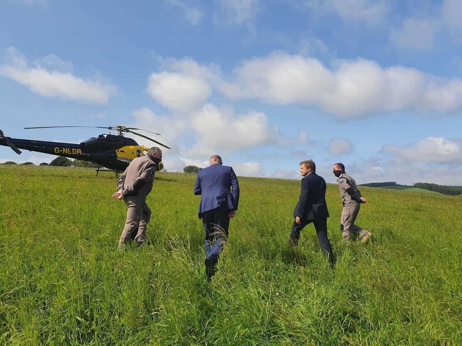 Andrew Haines (second left) and Transport Minister Grant Schapps (third left) surveyed the scene by helicopter earlier today.