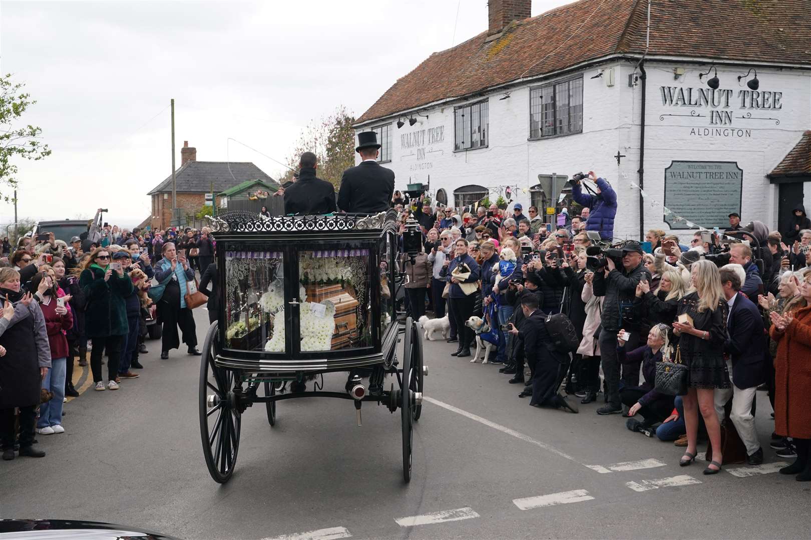 The funeral cortege of Paul O’Grady travels through the village of Aldington, Kent (Yui Mok/PA)