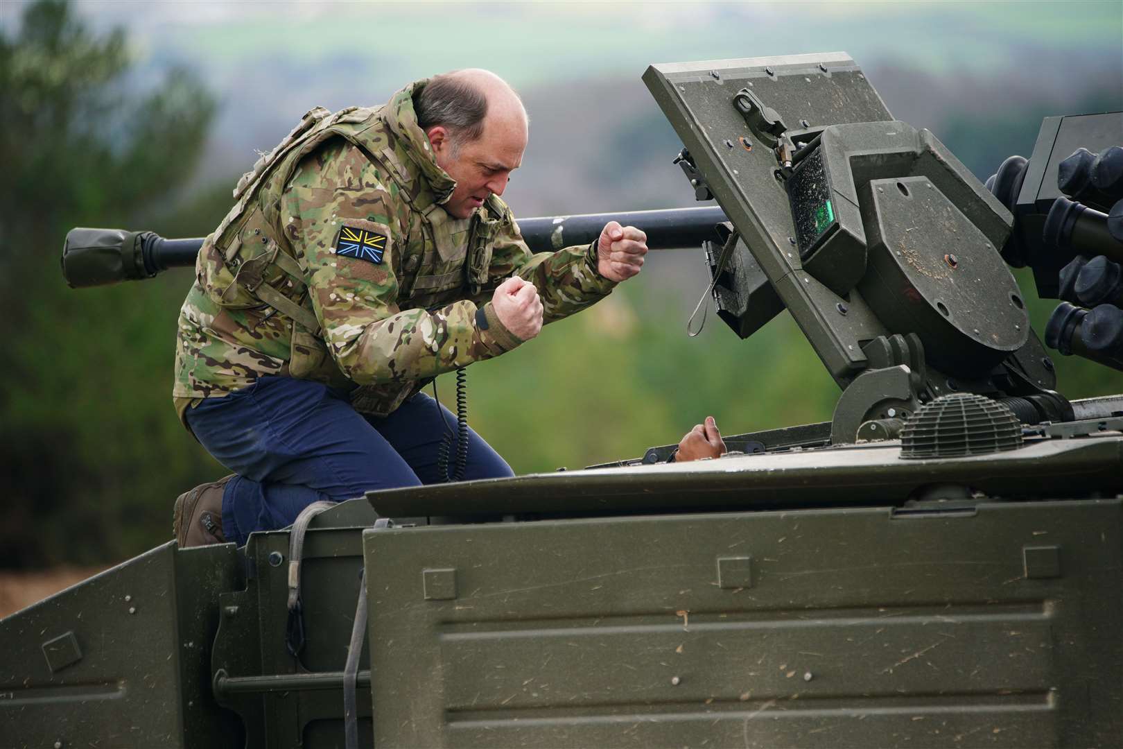 Defence Secretary Ben Wallace speaks to the crew inside an Ajax armoured personnel at Bovington Camp (Ben Birchall/PA Wire)