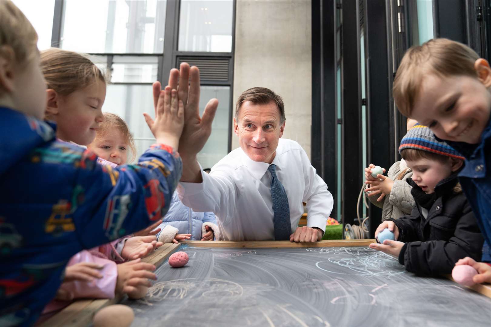 Chancellor of the Exchequer Jeremy Hunt, meeting children during a visit to Busy Bees Battersea Nursery in south London, after delivering his Budget (Stefan Rousseau/PA)