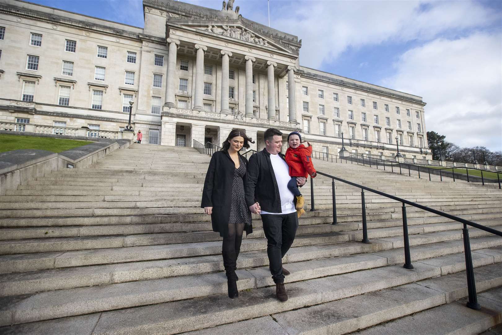 Daithi MacGabhann with his dad Mairtin MacGabhann and mother Seph Ni Mheallain on the steps of Parliament Buildings at Stormont in Belfast (Liam McBurney/PA)