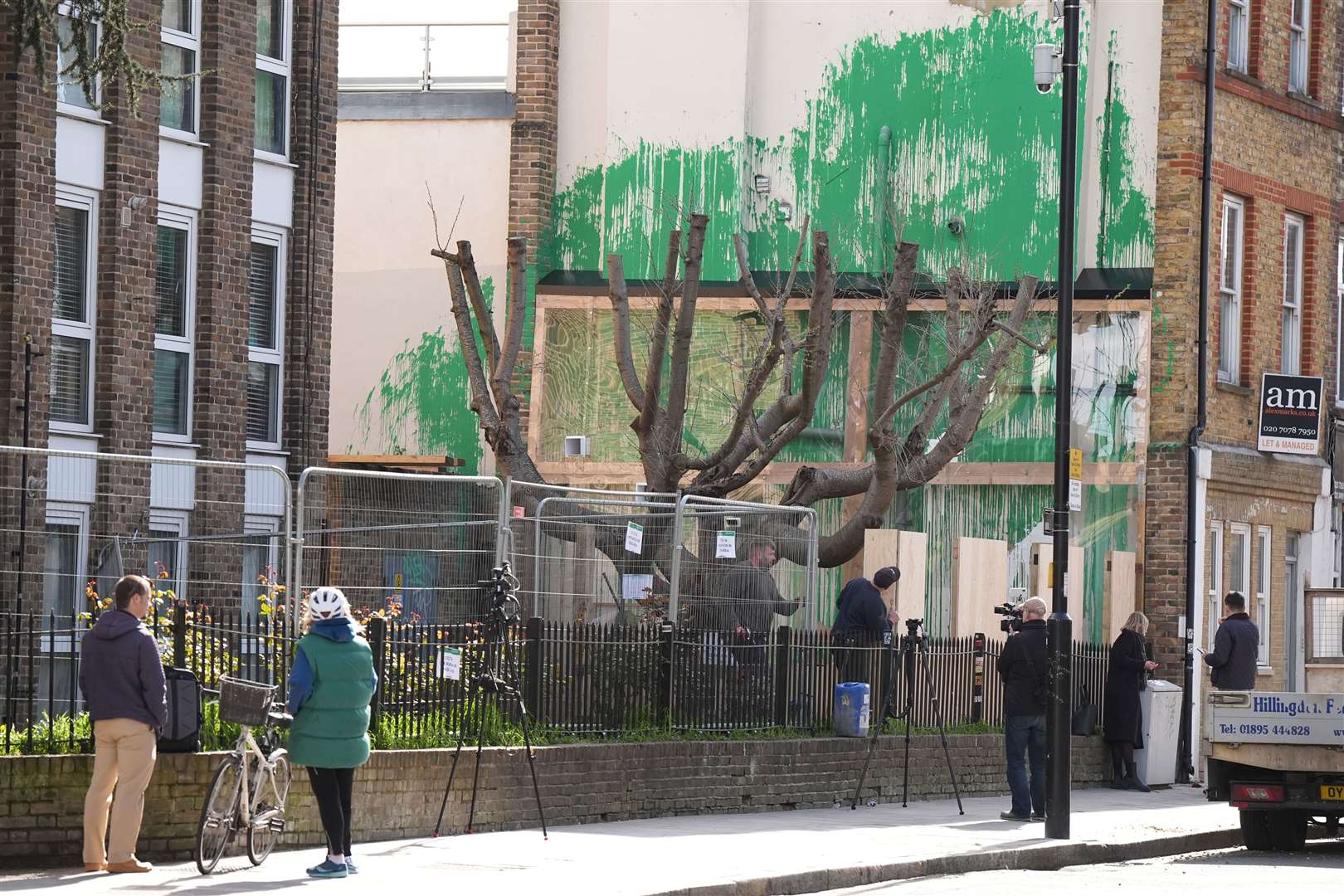 Fencing and plastic sheeting have been put up next to the Banksy artwork in Hornsey Road, Finsbury Park, after it was defaced with white paint last week (Aaron Chown/PA)
