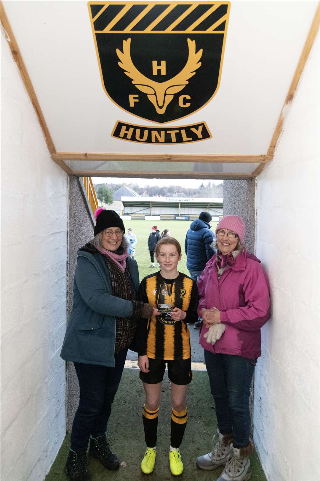 Huntly Women's Lucy Taylor was awarded Player of the Match by Huntly Ethical Trading Initiative members Ellie Turner (left) and Jane Taylor (right)...Huntly Women's F.C. v Inverurie Loco Works F.C Ladies at Christie Park...Picture: Beth Taylor.