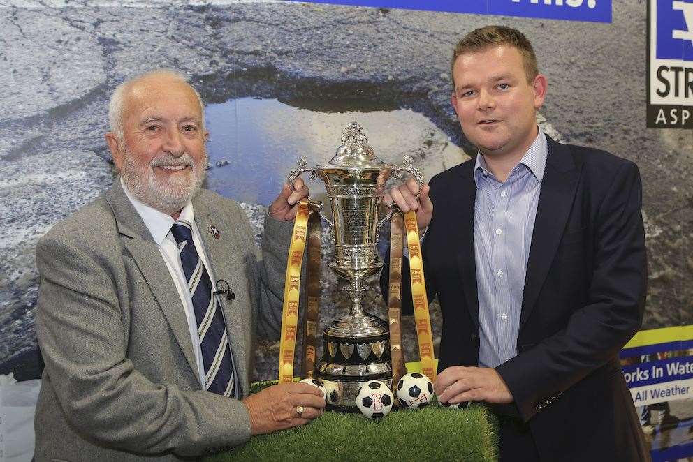 The Highland League Cup trophy, held by Highland League president George Manson and GHP Builders Merchants managing director Grant Shewan.