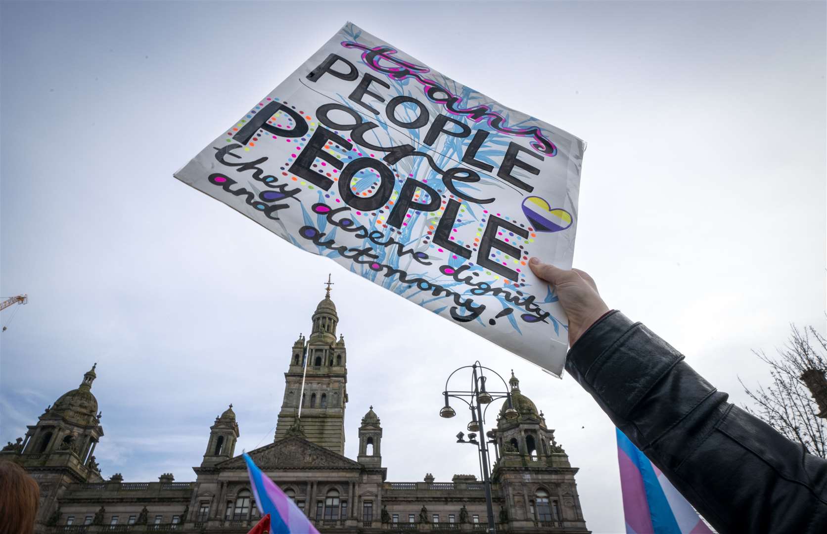 Trans rights activists danced and sang just metres from the Standing for Women rally (Jane Barlow/PA)