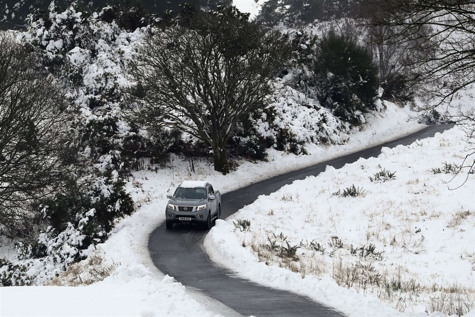 A motorist driving through snow covered fields near Auchterarder, Perthshire (Andrew Milligan/PA)