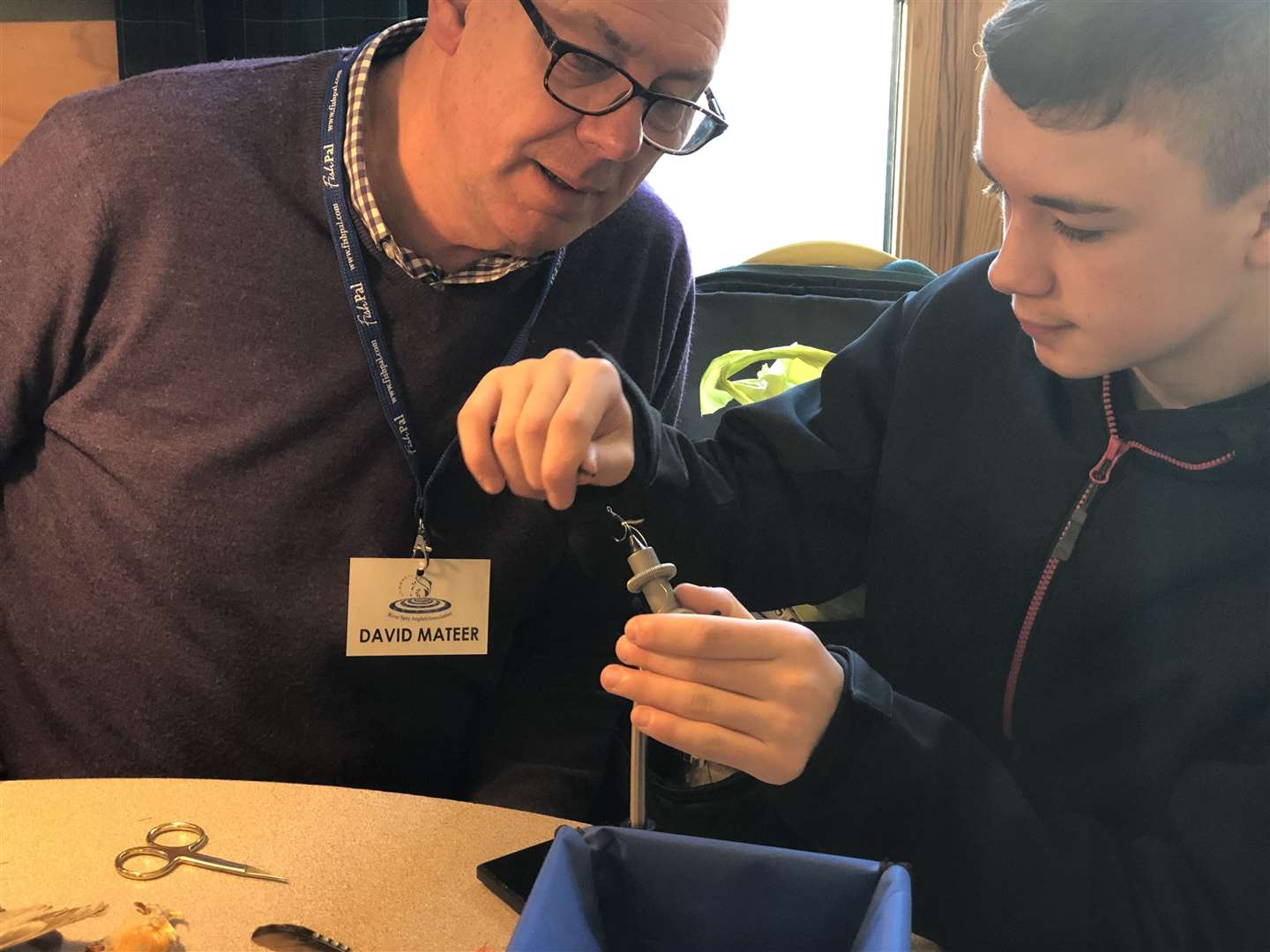 David Mateer from the RSAA gives a budding angler some fly tying tips. Picture: RSAA