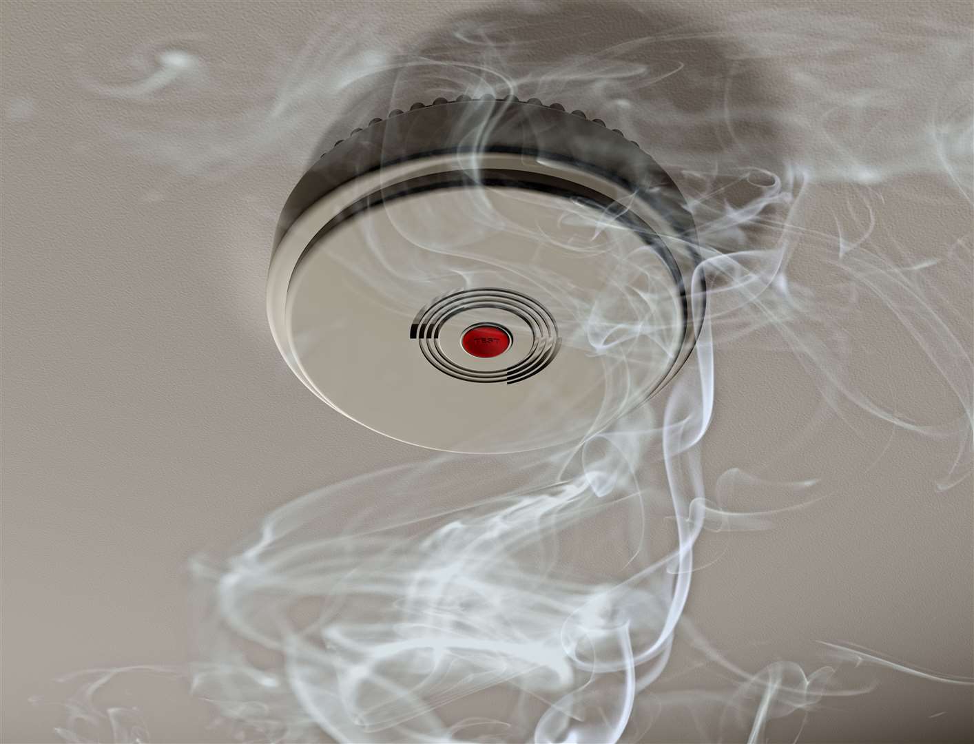 Illustration of a smoke alarm sounding off in a smoky room.