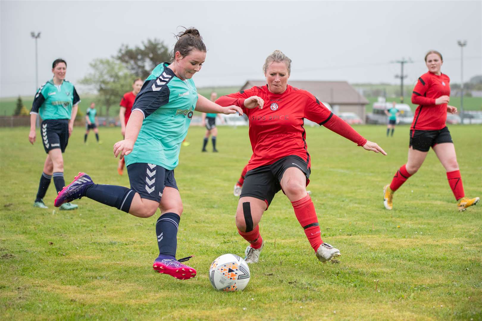 Buckie Ladies' Alena Gardiner is tracked by Brora's Mary Stewart as she looks to cross the ball into the box...Buckie Ladies FC (8) vs Brora Rangers Ladies FC (1) - SWF Highlands and Islands League - Gordon Park, Portgordon 14/05/2023...Picture: Daniel Forsyth..