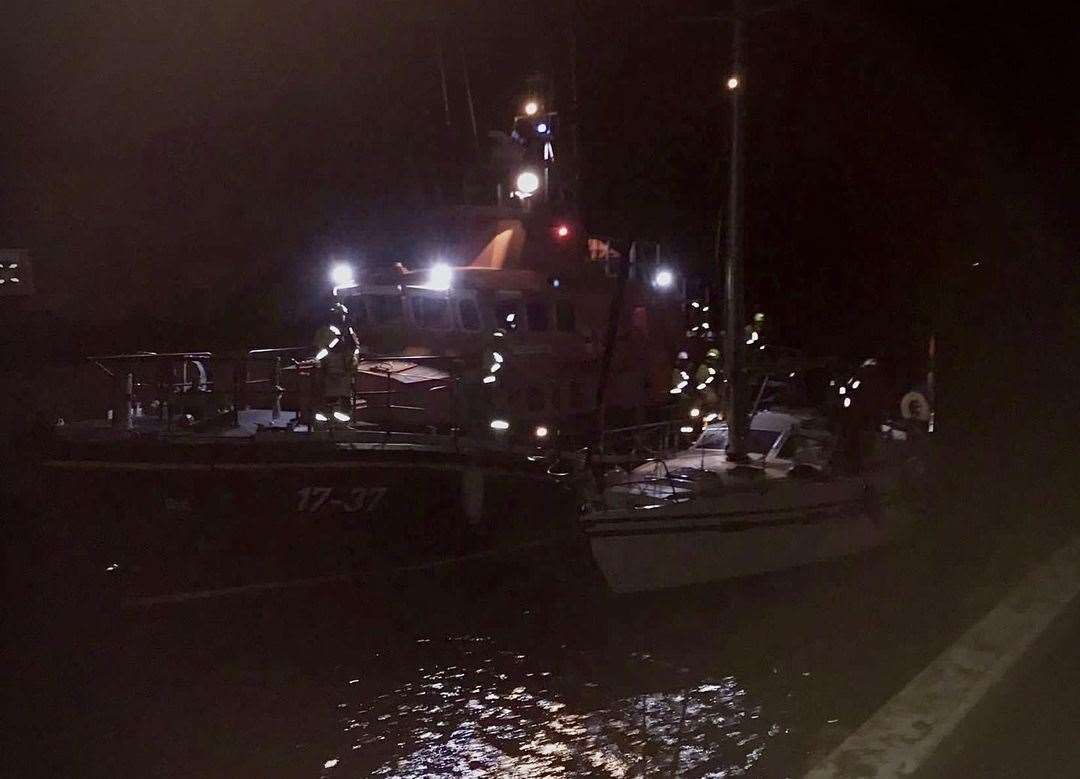 Safely home – Buckie lifeboat nudges the stricken yacht to her moorings at Lossiemouth Harbour. Picture: Buckie RNLI