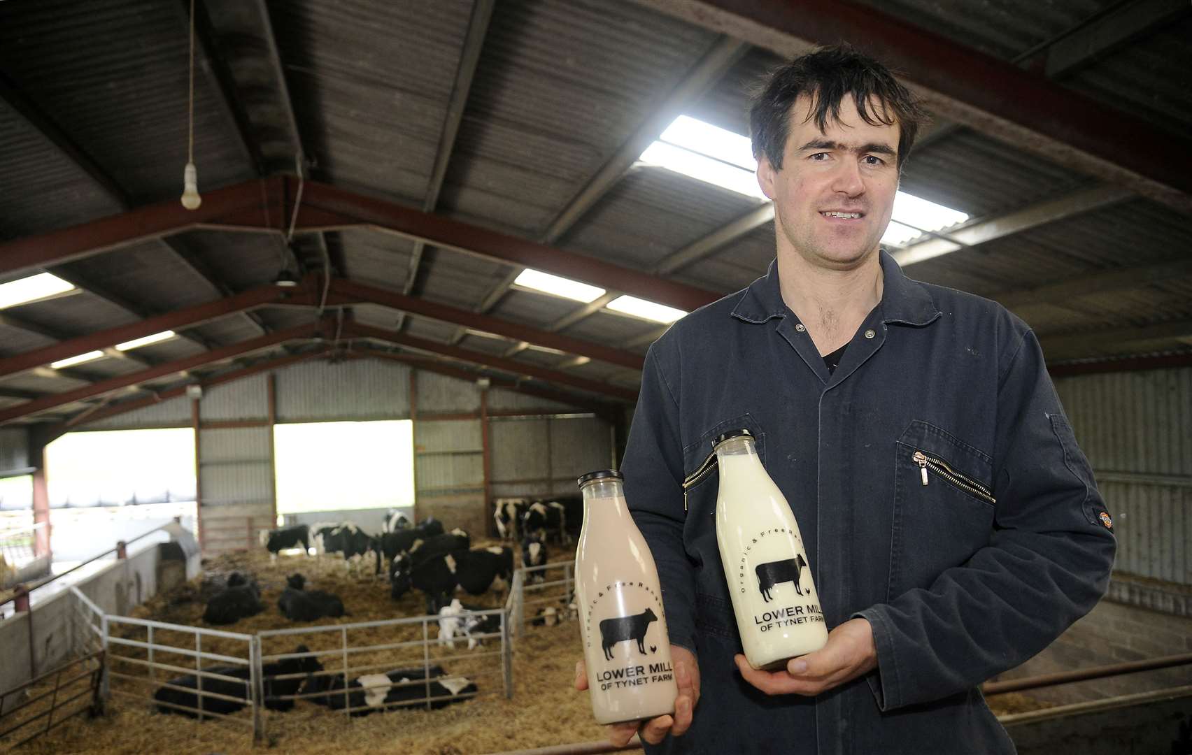 Gordon Whiteford shows off some of the milk produced at the farm which helped secure the #FoodHeroScot title. Picture: Becky Saunderson