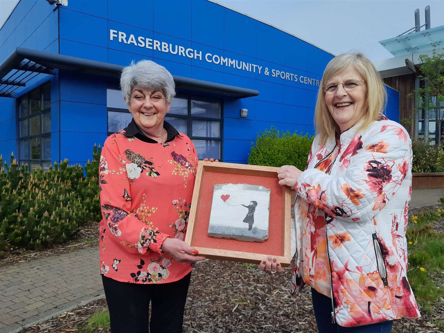 Fraserburgh councillors Ann Bell and Banff and Buchan Area Committee chair Doreen Mair with the Banksy-inspired stones and some of the pavers