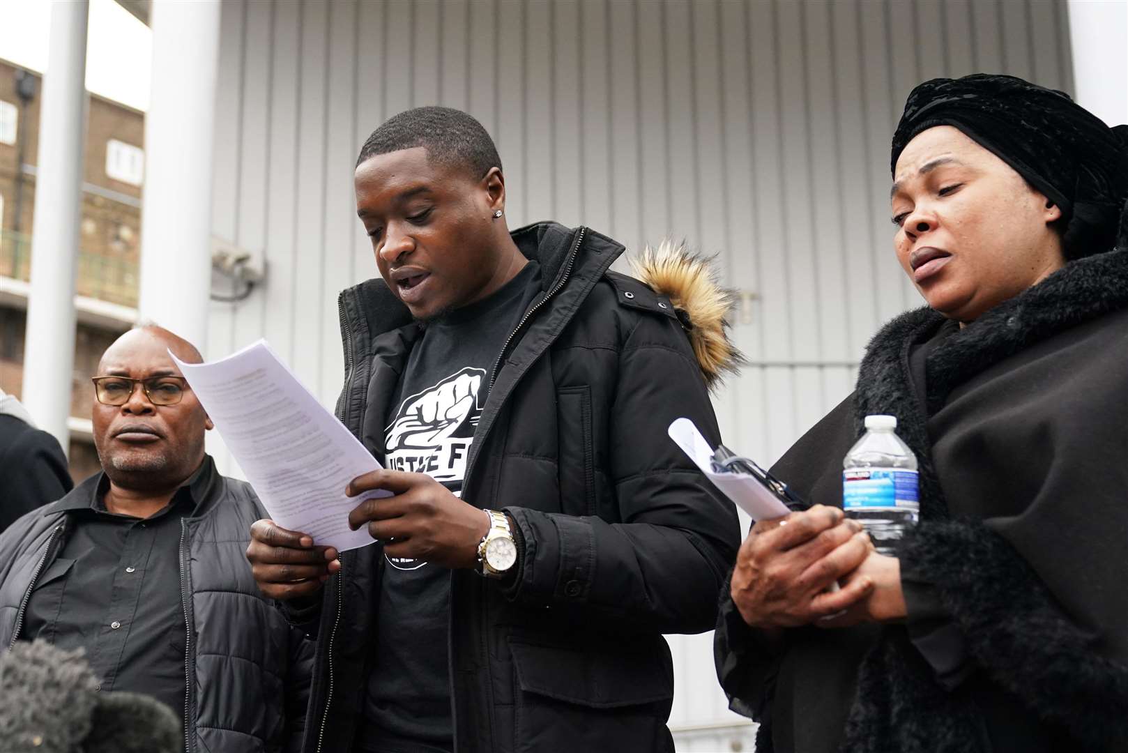 Chris Kaba’s cousin Jefferson Bosela spoke outside the first inquest hearing into his death last year, alongside Chris’s parents Prosper Kaba (left) and Helen Lumuanganu (Victoria Jones/PA)