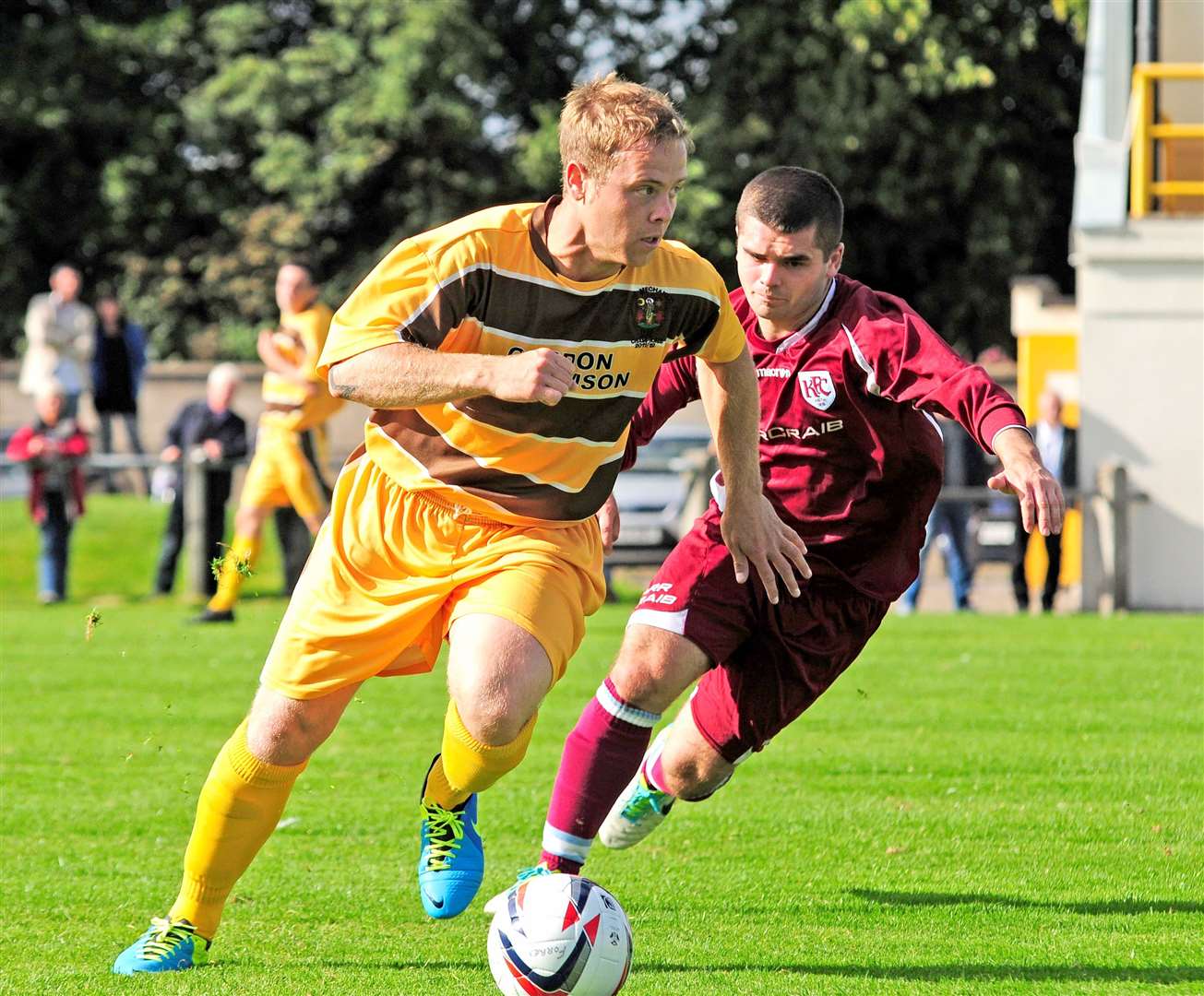 Andy MacAskill in a Keith shirt, contesting possession with Forres defender Simon Allan. Picture: Daniel Forsyth.