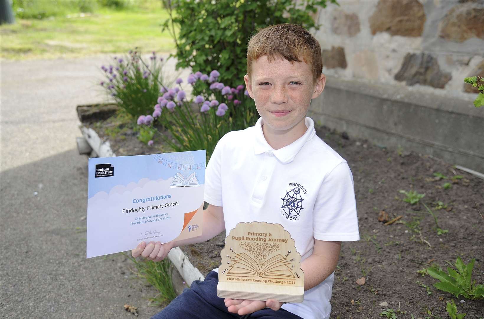 Caleb Watt proudly shows off his P6 Pupil Reading Journey award. Picture: Becky Saunderson