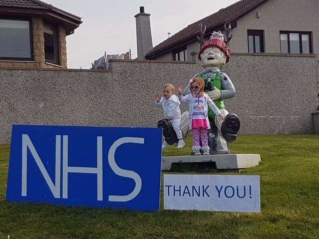 Young brother and sister Zenia and Karter Watt with the colourful Oor Wullie and the sign thanking the NHS.
