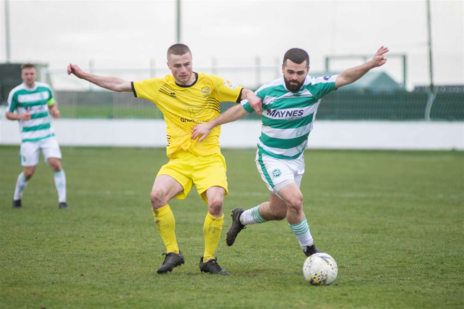 Clachnacuddin's Rorie Macleod links arms with Buckie's Andy MacAskill as the chase a ball down at Victoria Park. ..Picture: Daniel Forsyth..
