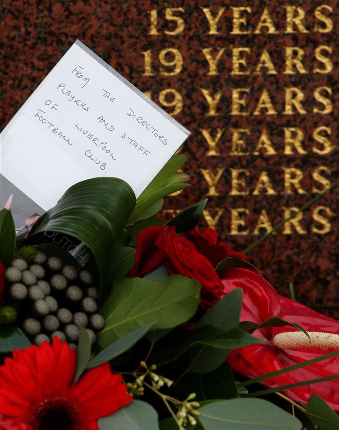 A floral tribute from Liverpool FC in front of the Hillsborough Memorial before a memorial service at Liverpool’s Anfield stadium (Dave Thompson/PA)