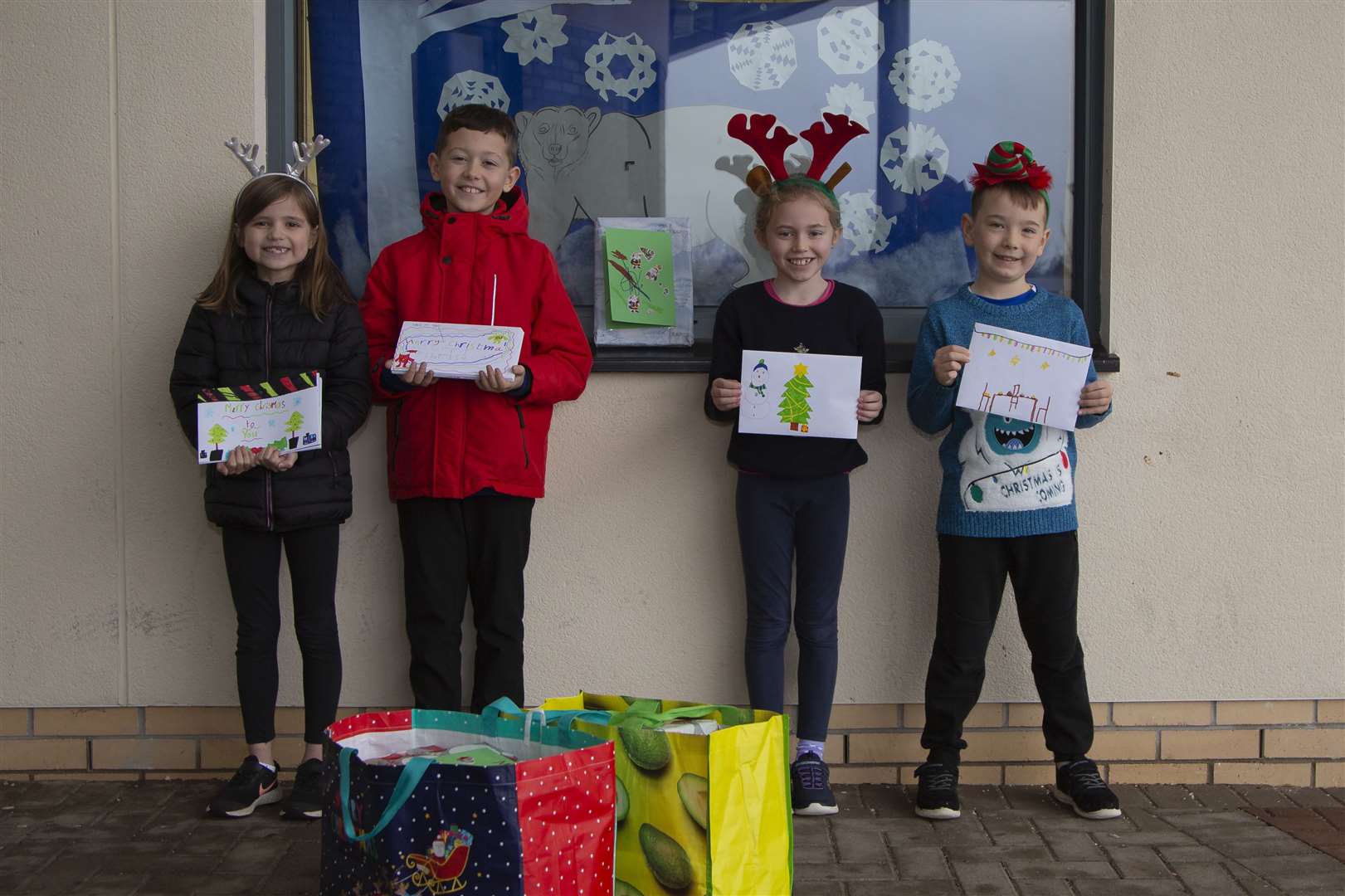 Kintore Primary School pupils Hannah, Charlie, Katie and Lewis with the Christmas cards they made. Picture: Paul Douglas.