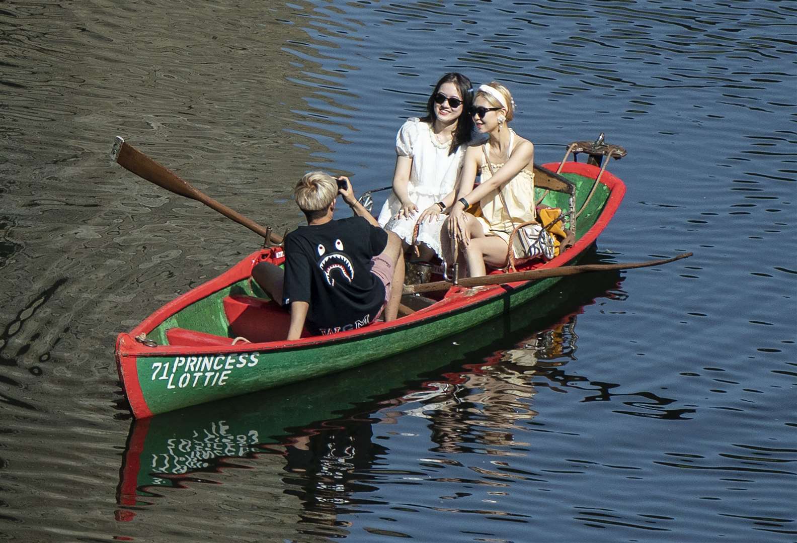 People in a rowing boat enjoy the hot weather on the River Nidd in Knaresborough (Danny Lawson/PA)