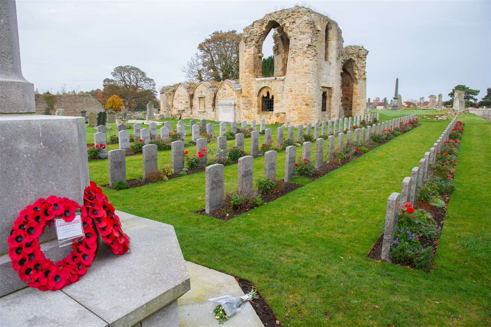 Wreaths and flowers are laid at the war memorial near the Commonwealth War Graves at Kinloss Abbey on Remembrance Sunday 2020. Picture: Daniel Forsyth.