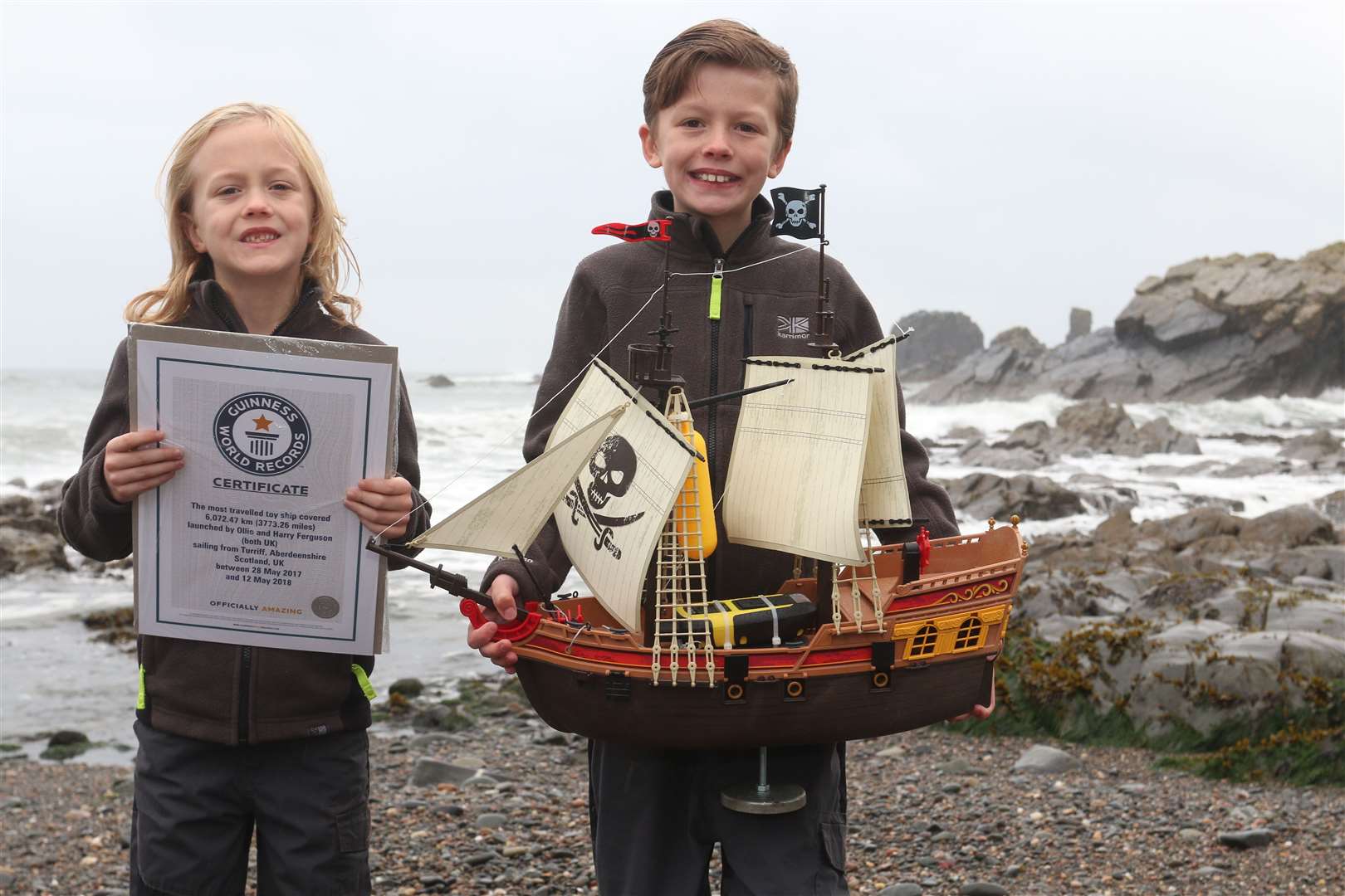 World record holders Harry (left) and Ollie Ferguson with their own replica of the ship Adventure. Picture: David Porter