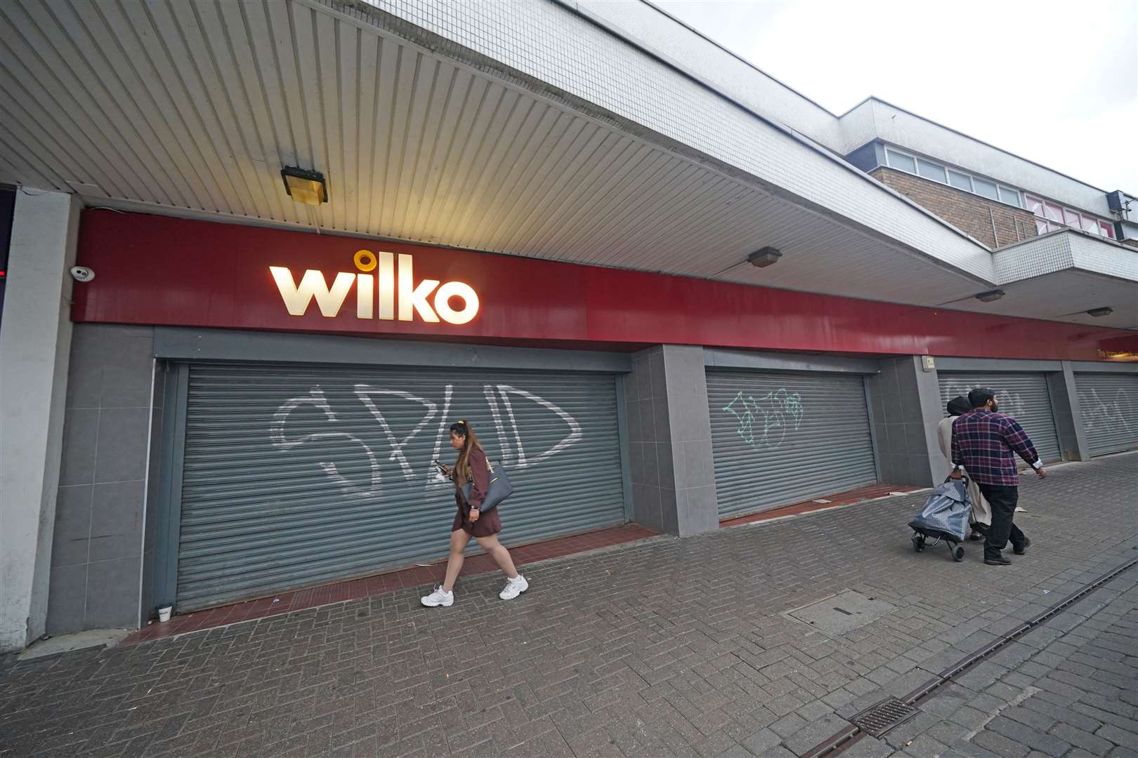 People walk past the closed Wilko store in Barking, east London, after its final day of trading on Tuesday (Yui Mok/PA)