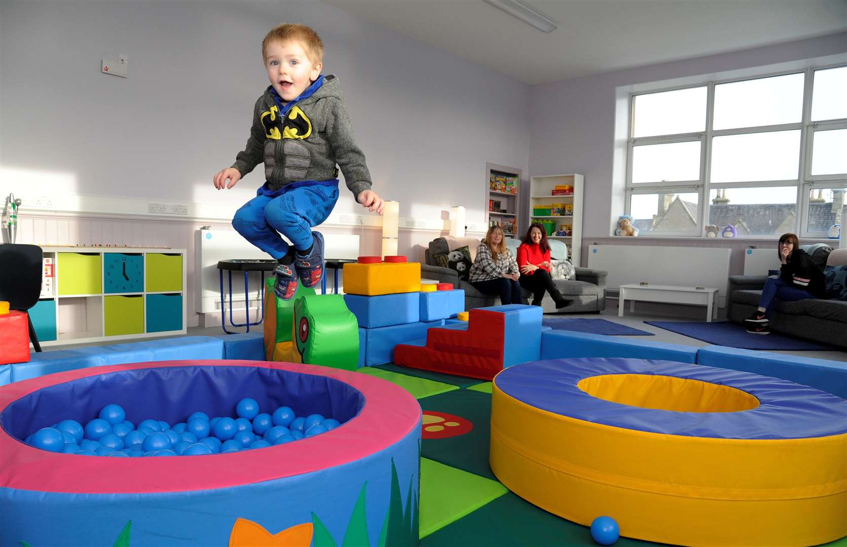 Jumping for joy...Aedyn Logan (4) has fun in the Action for Children play area at Lady Cathcart watched by mum Christine (back middle), a course student, fellow student Kirsty Smith (back right) and children services manager Sheila Erskine. Picture: Eric Cormack