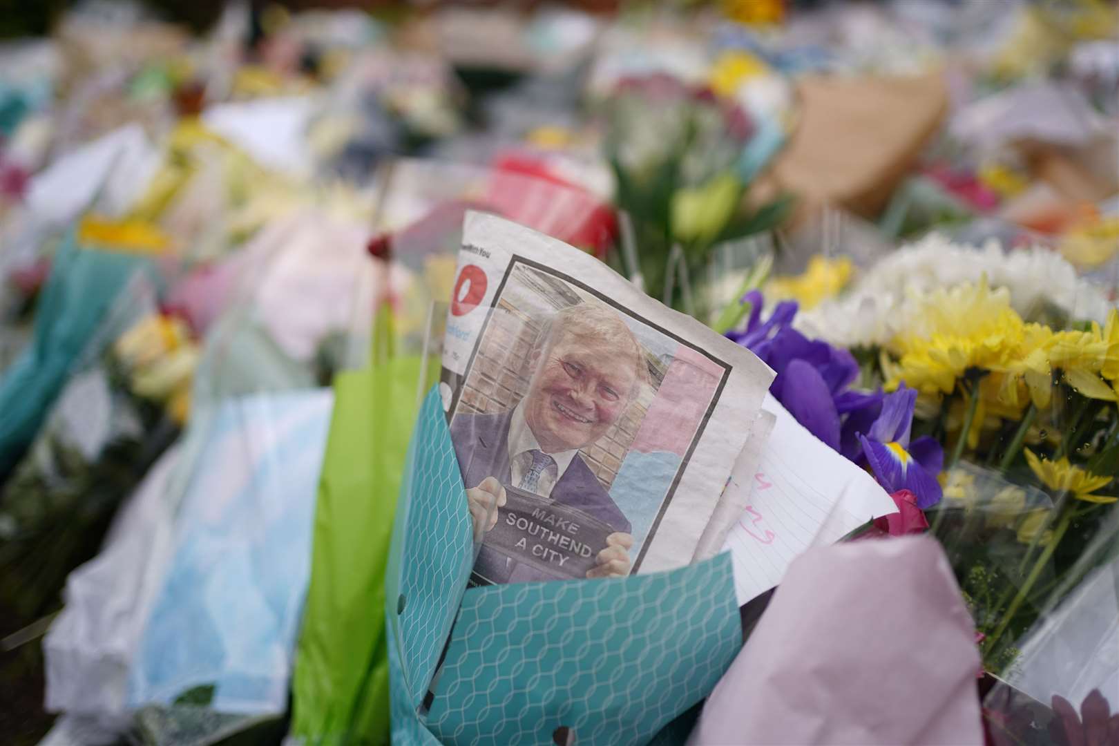An edition of the Southend Echo tucked into one of the floral tributes left outside the Belfairs Methodist Church in Leigh-on-Sea, Essex, where Conservative MP Sir David Amess was killed on Friday.