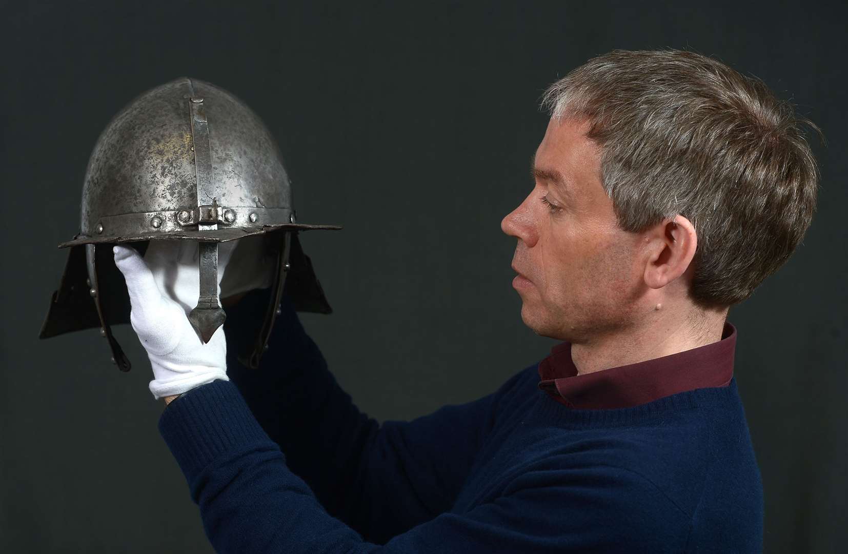 Hugh Morrison, HES collections registrar, with a Continental or Dutch pot style helmet which is part of the Romantic Scotland exhibition at Duff House.