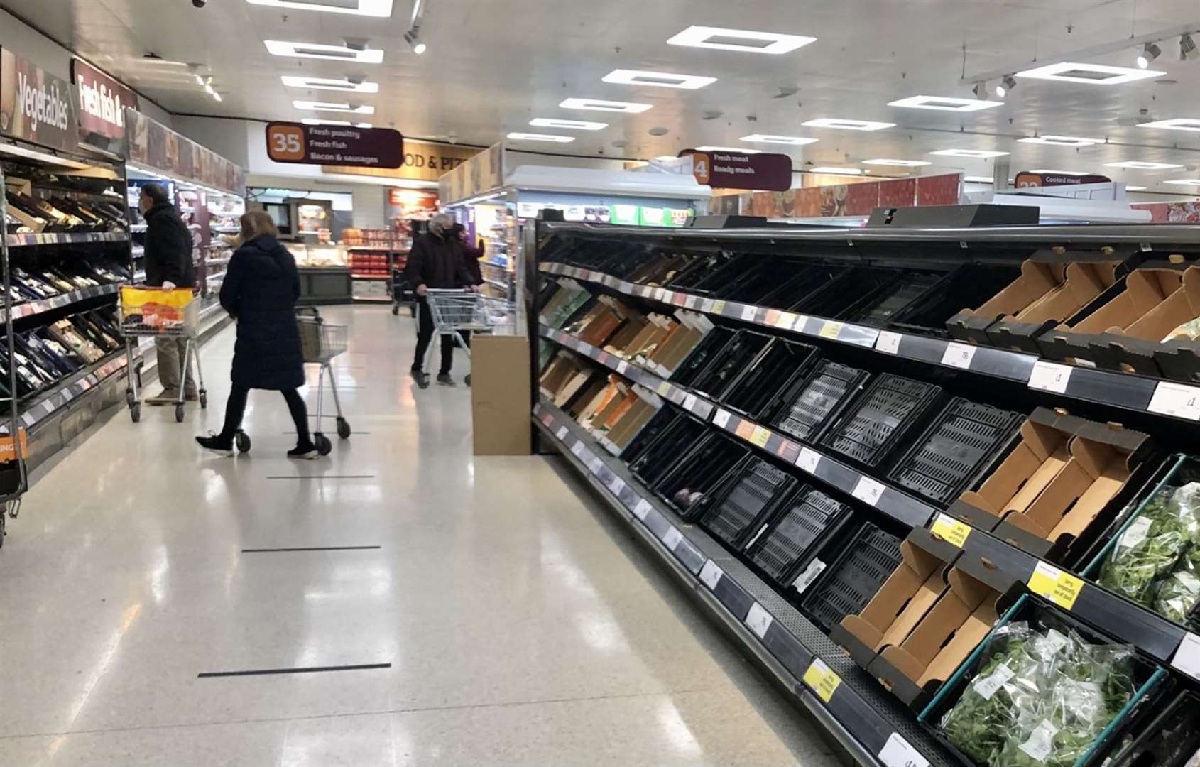 Depleted shelves in Sainsbury’s at the Forestside shopping centre in Belfast (David Young/PA)